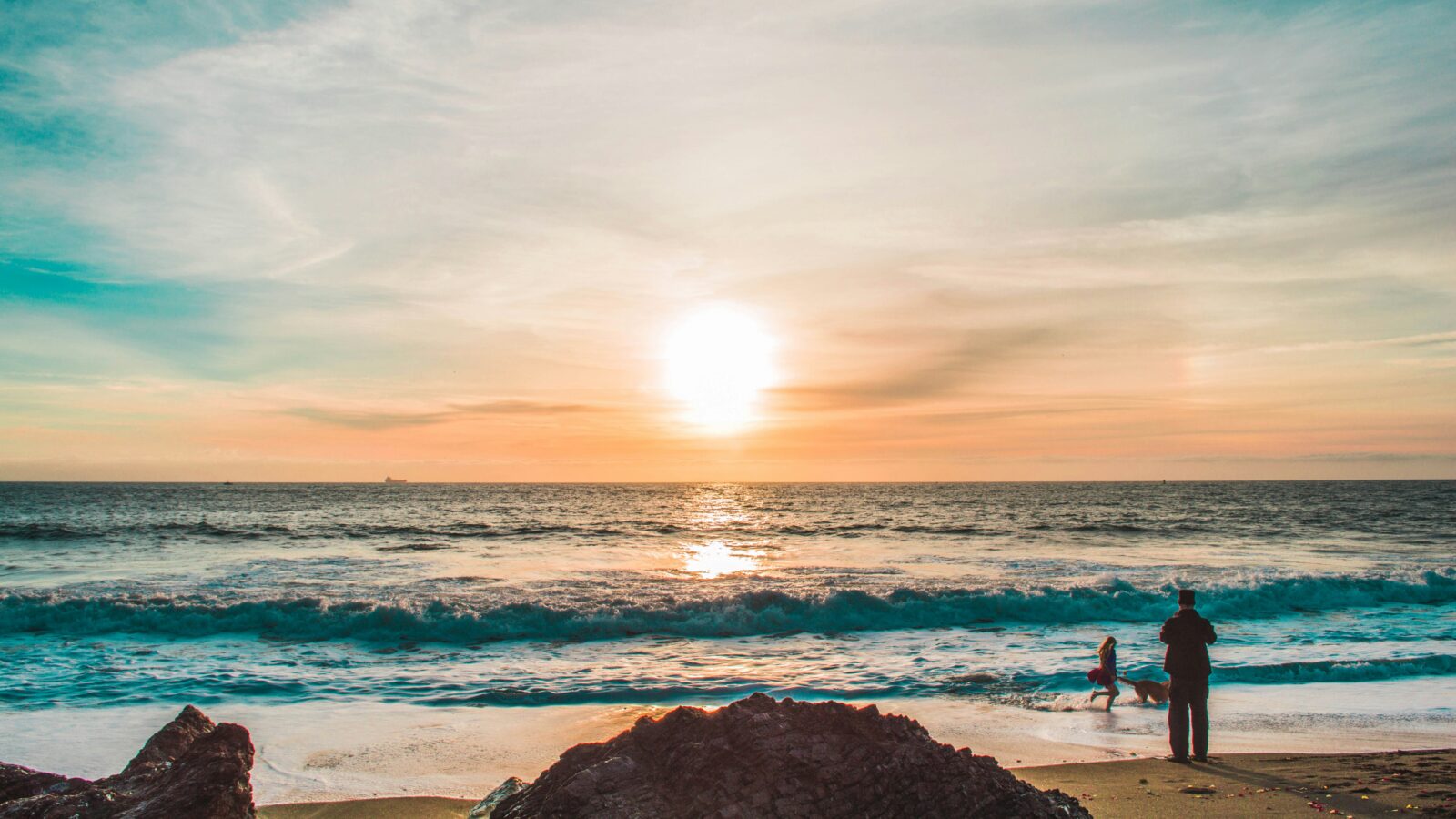 Sunrise beach with dog and kid