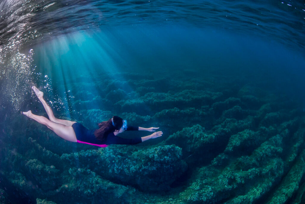 Girl snorkelling underwater in the mediterranena sea
