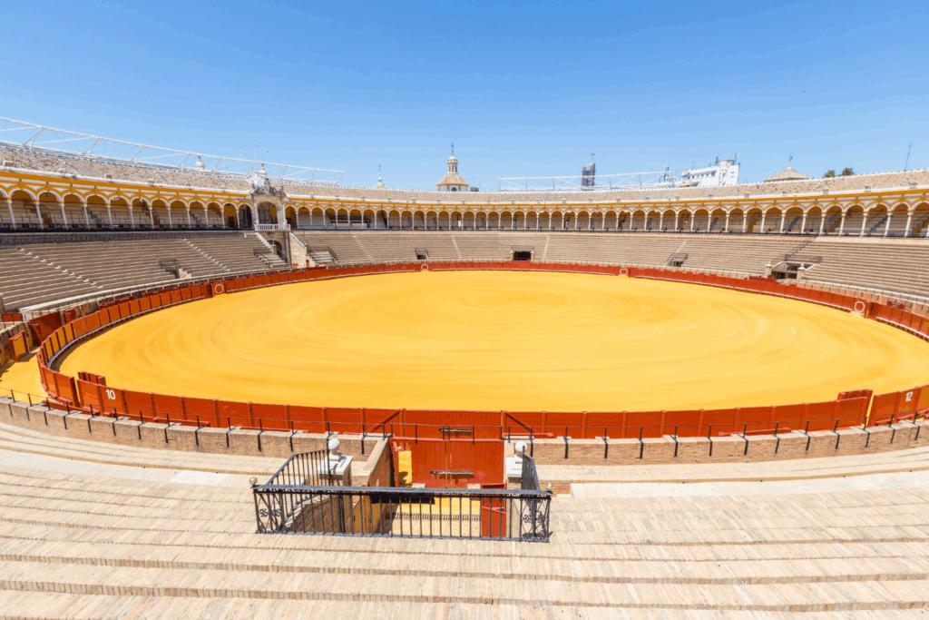 A view of the plaza de toros, yellow arena, red barrior